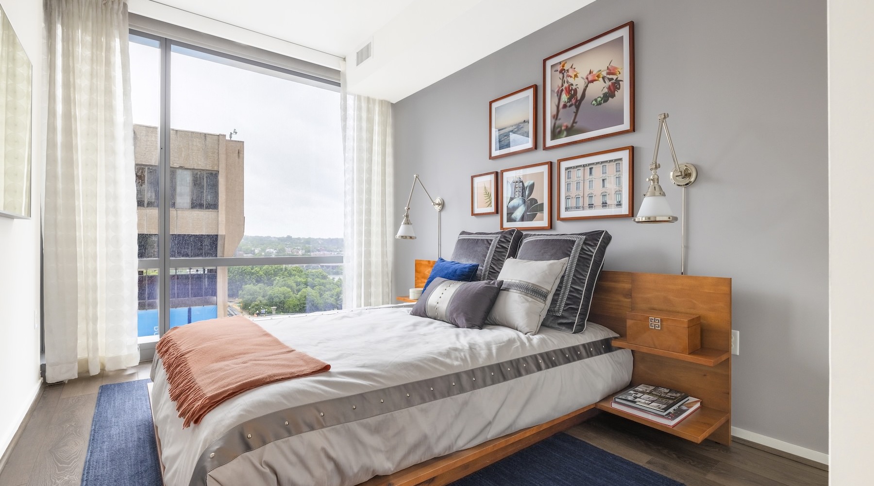 a bedroom with a bed and a large window