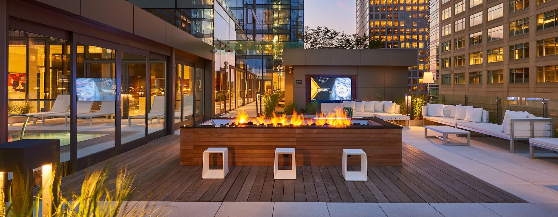 a courtyard with chairs and a fire pit
