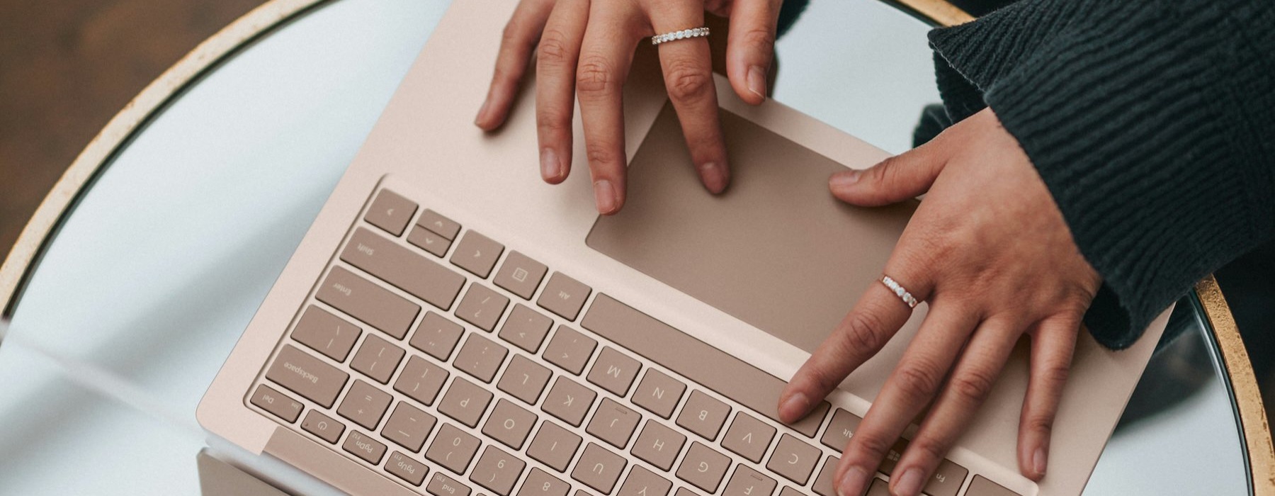 a person sitting at a table with a laptop